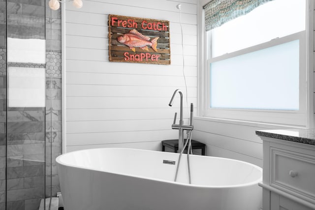2051 SW Pruitt St, Port Saint Lucie, FL 34953 - bathroom with healthy amount of natural light, a freestanding tub, and vanity