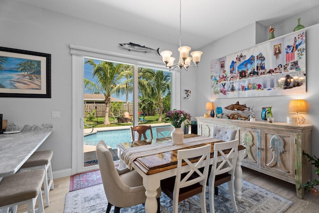 2051 SW Pruitt St, Port Saint Lucie, FL 34953 - dining area with light wood-style floors and a chandelier