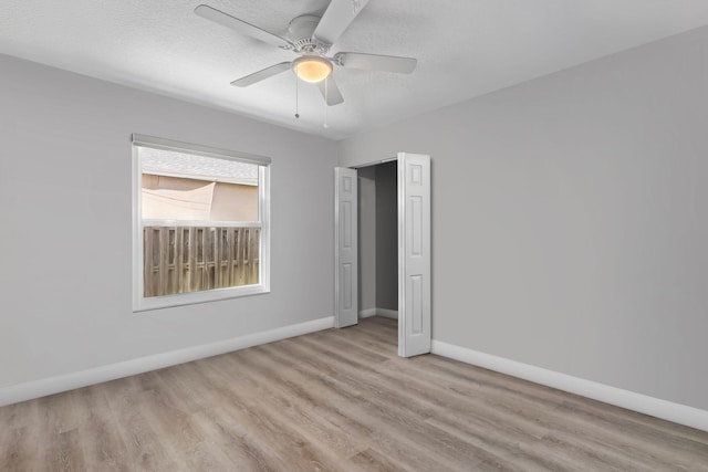 2051 SW Pruitt St, Port Saint Lucie, FL 34953 - unfurnished bedroom with wood finished floors, a textured ceiling, and a ceiling fan