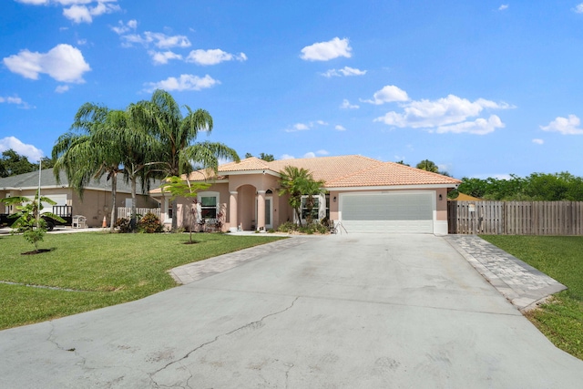 2051 SW Pruitt St, Port Saint Lucie, FL 34953 - mediterranean / spanish home with stucco siding, concrete driveway, a garage, and a tiled roof