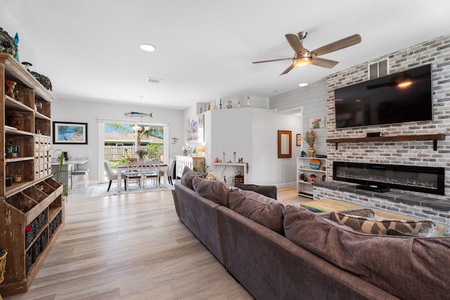 2051 SW Pruitt St, Port Saint Lucie, FL 34953 - living room featuring a fireplace, ceiling fan, light wood-type flooring, and recessed lighting