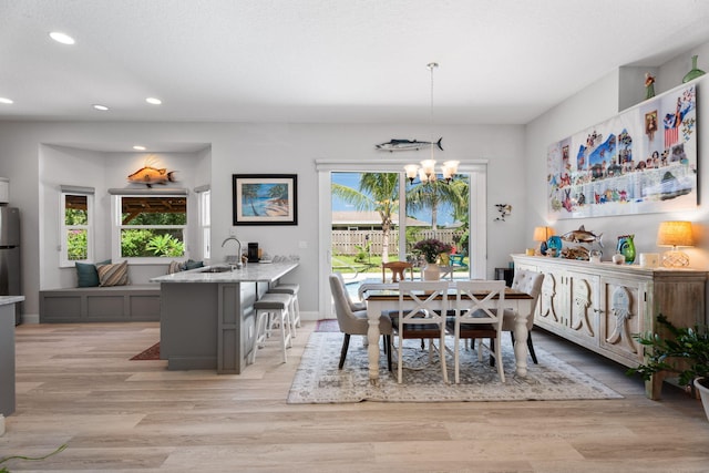 2051 SW Pruitt St, Port Saint Lucie, FL 34953 - dining area featuring recessed lighting, a chandelier, and light wood-type flooring