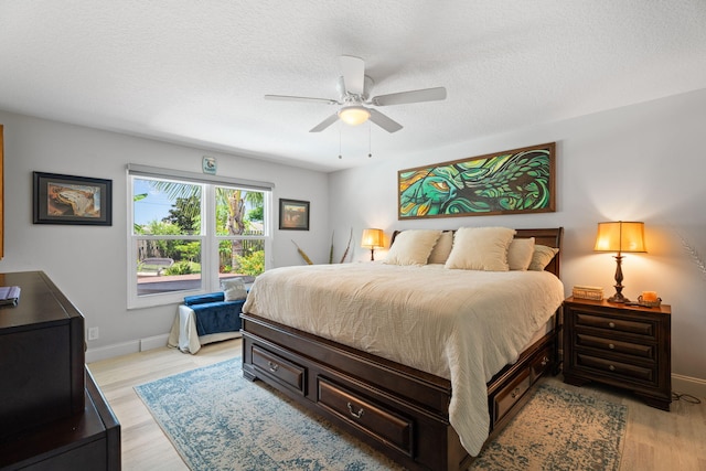 2051 SW Pruitt St, Port Saint Lucie, FL 34953 - bedroom featuring light wood-style floors, ceiling fan, and a textured ceiling
