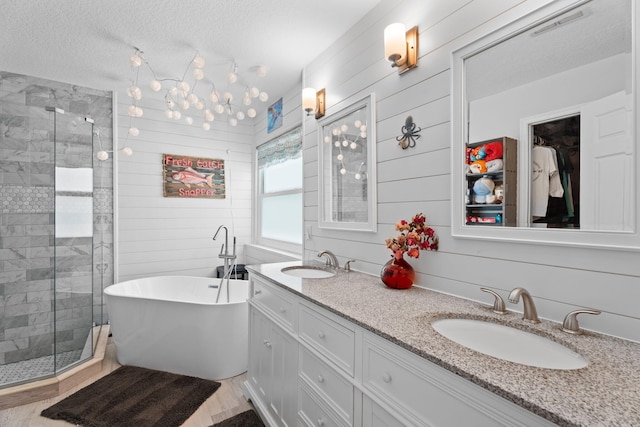 2051 SW Pruitt St, Port Saint Lucie, FL 34953 - full bath featuring a stall shower, double vanity, a soaking tub, and a textured ceiling