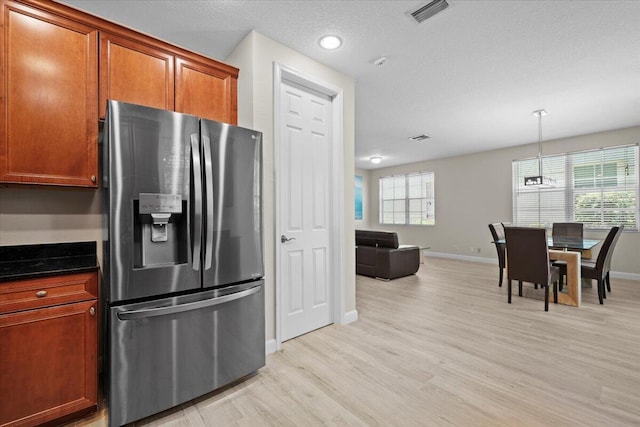 615 Castle Dr, Palm Beach Gardens, FL 33410 - kitchen with stainless steel refrigerator with ice dispenser, light wood finished floors, brown cabinets, pendant lighting, and recessed lighting
