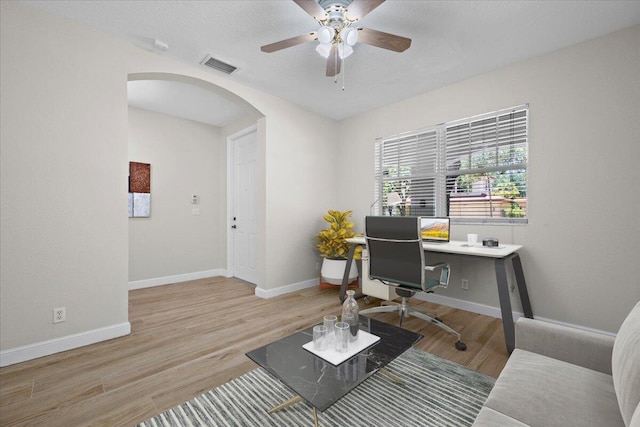 615 Castle Dr, Palm Beach Gardens, FL 33410 - office featuring arched walkways, wood finished floors, and ceiling fan