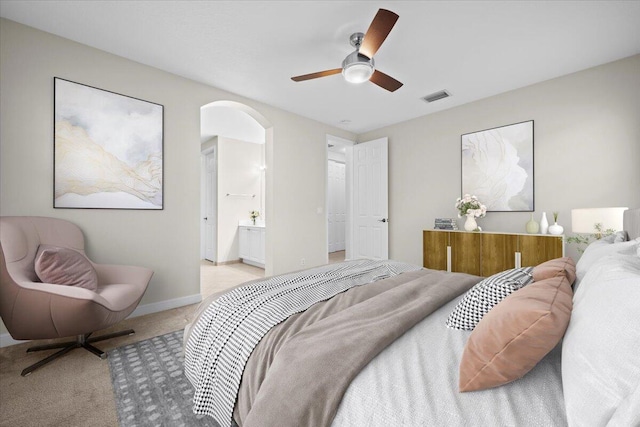 615 Castle Dr, Palm Beach Gardens, FL 33410 - bedroom featuring arched walkways, light carpet, ceiling fan, and ensuite bathroom