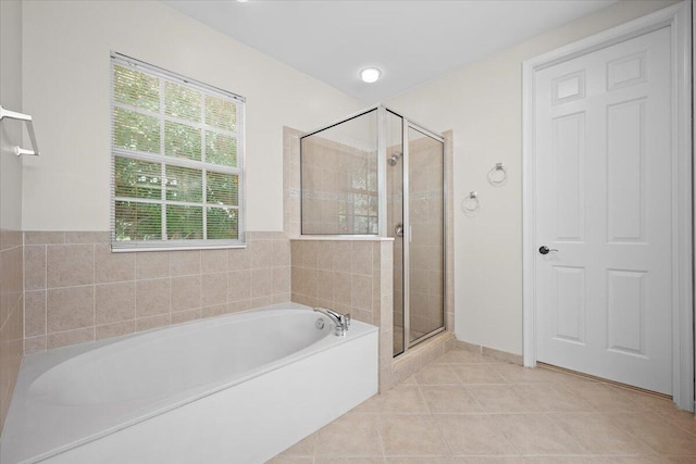 615 Castle Dr, Palm Beach Gardens, FL 33410 - bathroom featuring a garden tub, a stall shower, and tile patterned floors