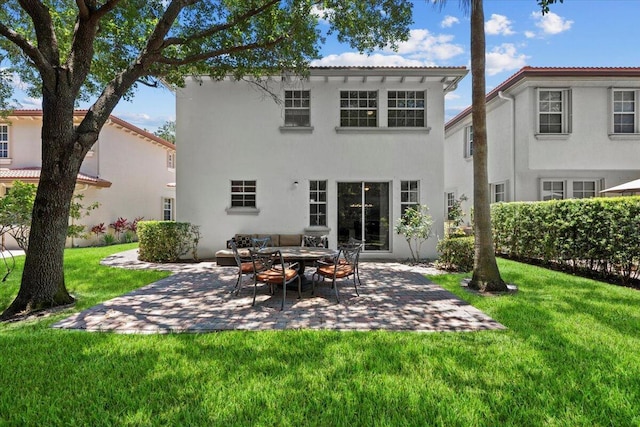 615 Castle Dr, Palm Beach Gardens, FL 33410 - back of house with a patio, a yard, and stucco siding