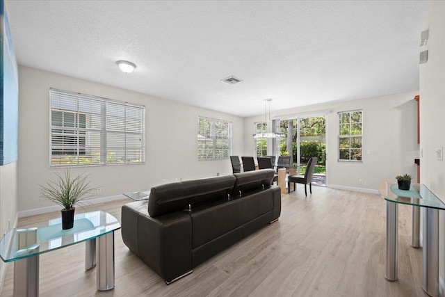 615 Castle Dr, Palm Beach Gardens, FL 33410 - living area with light wood finished floors and a textured ceiling