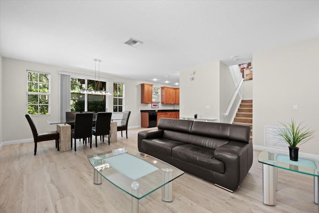 615 Castle Dr, Palm Beach Gardens, FL 33410 - living room with light wood-type flooring and stairway