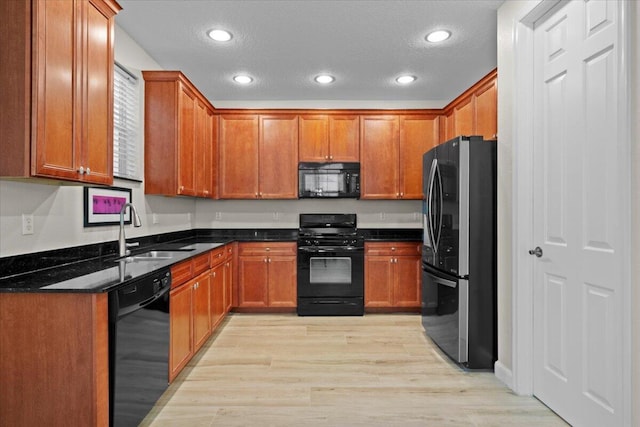 615 Castle Dr, Palm Beach Gardens, FL 33410 - kitchen with black appliances, recessed lighting, light wood-style flooring, brown cabinets, and a textured ceiling
