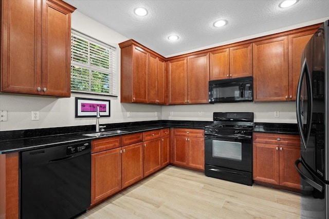 615 Castle Dr, Palm Beach Gardens, FL 33410 - kitchen featuring black appliances, recessed lighting, brown cabinets, light wood-type flooring, and a textured ceiling