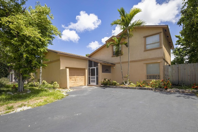 3896 NW 2nd Ct, Deerfield Beach, FL 33442 - view of front of house featuring stucco siding, a garage, and asphalt driveway