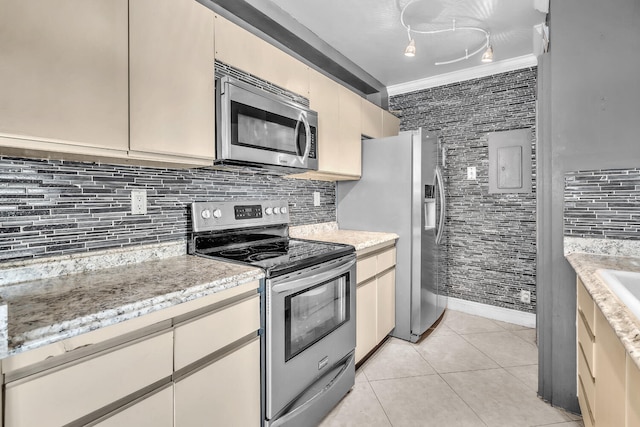 19667 Turnberry Way Unit 10C, Aventura, FL 33180 - kitchen featuring stainless steel appliances, light tile patterned floors, cream cabinetry, and backsplash