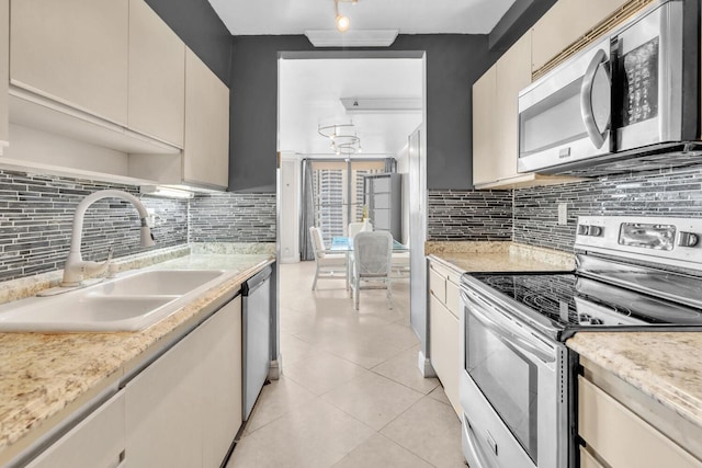 19667 Turnberry Way Unit 10C, Aventura, FL 33180 - kitchen featuring stainless steel appliances, backsplash, and light tile patterned floors