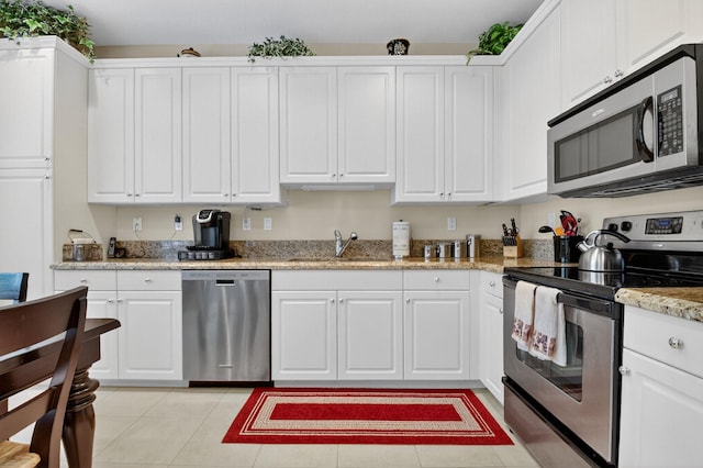 7271 Briella Dr, Boynton Beach, FL 33437 - kitchen with appliances with stainless steel finishes, white cabinets, light stone countertops, and light tile patterned flooring