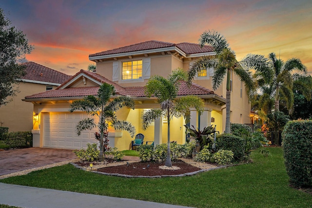 6126 SE Split Oak Trl, Hobe Sound, FL 33455 - mediterranean / spanish house with a tile roof, driveway, stucco siding, and a front yard