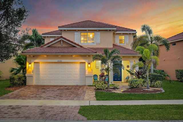 6126 SE Split Oak Trl, Hobe Sound, FL 33455 - mediterranean / spanish house featuring decorative driveway, a tiled roof, stucco siding, and a front lawn