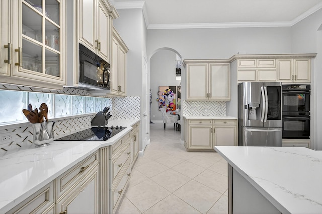 8168 Valhalla Dr, Delray Beach, FL 33446 - kitchen with black appliances, cream cabinetry, ornamental molding, and tasteful backsplash