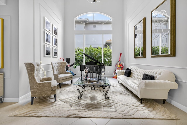 8168 Valhalla Dr, Delray Beach, FL 33446 - tiled living room featuring baseboards and a high ceiling