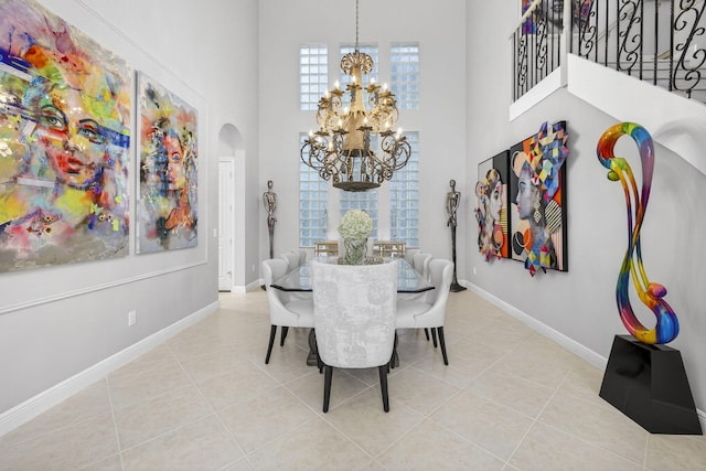 8168 Valhalla Dr, Delray Beach, FL 33446 - tiled dining area featuring arched walkways, a chandelier, and a towering ceiling