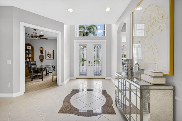 8168 Valhalla Dr, Delray Beach, FL 33446 - tiled entrance foyer featuring arched walkways, french doors, a ceiling fan, and recessed lighting