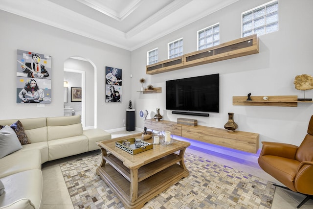 8168 Valhalla Dr, Delray Beach, FL 33446 - living area featuring ornamental molding, arched walkways, a raised ceiling, and a towering ceiling