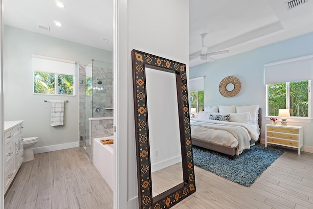 17742 Evangeline Ave, Jupiter, FL 33458 - bedroom featuring multiple windows, light wood-style floors, and recessed lighting