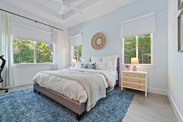 17742 Evangeline Ave, Jupiter, FL 33458 - bedroom with multiple windows, wood finished floors, and ceiling fan