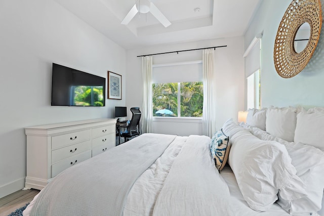 17742 Evangeline Ave, Jupiter, FL 33458 - bedroom featuring wood finished floors, a raised ceiling, ceiling fan, and a desk