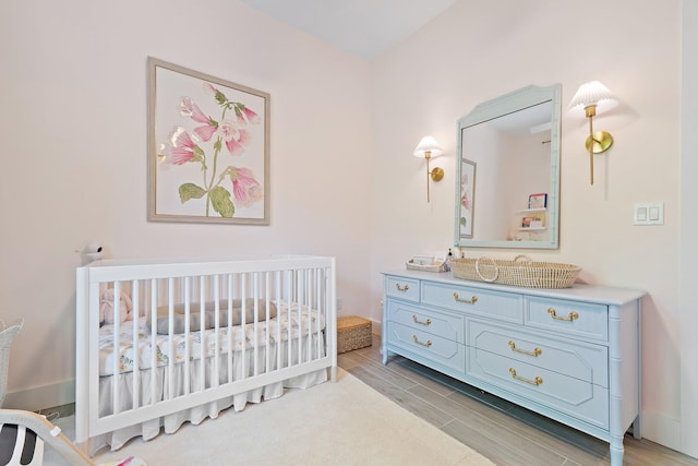 17742 Evangeline Ave, Jupiter, FL 33458 - bedroom with a crib and wood tiled floors