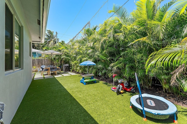17742 Evangeline Ave, Jupiter, FL 33458 - view of yard with a trampoline and a patio