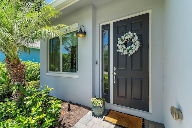 17742 Evangeline Ave, Jupiter, FL 33458 - doorway to property featuring stucco siding