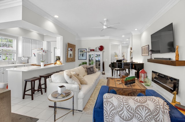 2002 Valencia Dr, Delray Beach, FL 33445 - living room with a ceiling fan, light tile patterned floors, a glass covered fireplace, recessed lighting, and crown molding