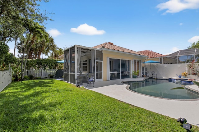 2002 Valencia Dr, Delray Beach, FL 33445 - rear view of property featuring a fenced backyard, a tiled roof, a pool with connected hot tub, stucco siding, and a patio