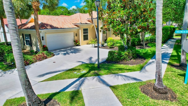 2002 Valencia Dr, Delray Beach, FL 33445 - mediterranean / spanish-style house with stucco siding, a garage, driveway, and a tiled roof