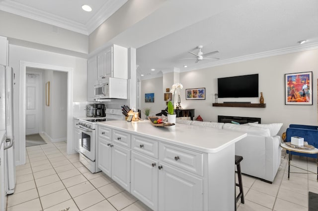 2002 Valencia Dr, Delray Beach, FL 33445 - kitchen featuring white appliances, light tile patterned floors, a ceiling fan, crown molding, and open floor plan