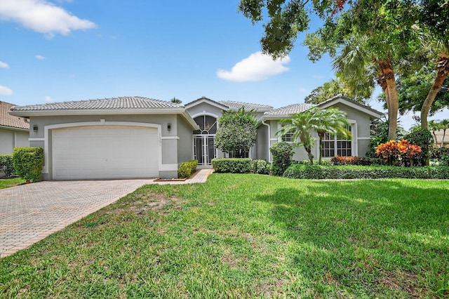 11291 Barca Blvd, Boynton Beach, FL 33437 - ranch-style home featuring a garage, stucco siding, a tiled roof, and decorative driveway