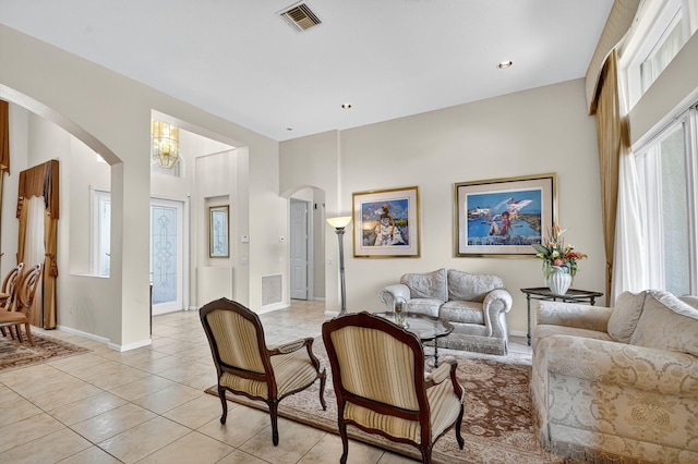 11291 Barca Blvd, Boynton Beach, FL 33437 - living room with arched walkways, light tile patterned floors, and a chandelier