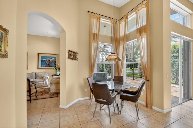 11291 Barca Blvd, Boynton Beach, FL 33437 - tiled dining room with arched walkways and a towering ceiling