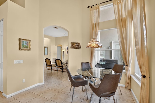 11291 Barca Blvd, Boynton Beach, FL 33437 - dining area featuring arched walkways, a towering ceiling, and tile patterned floors