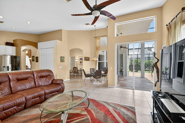 11291 Barca Blvd, Boynton Beach, FL 33437 - living room featuring arched walkways, ceiling fan, light tile patterned floors, recessed lighting, and a towering ceiling
