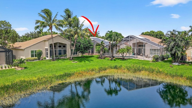 11291 Barca Blvd, Boynton Beach, FL 33437 - rear view of property featuring a water view, stucco siding, a yard, and a lanai