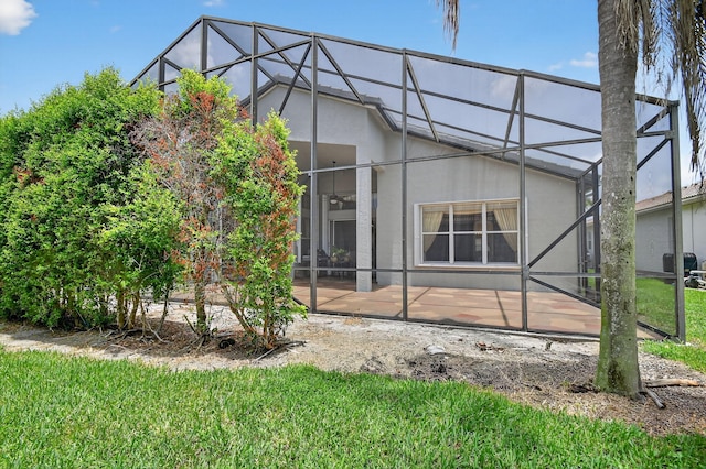 11291 Barca Blvd, Boynton Beach, FL 33437 - rear view of property featuring glass enclosure, a patio, stucco siding, and a yard