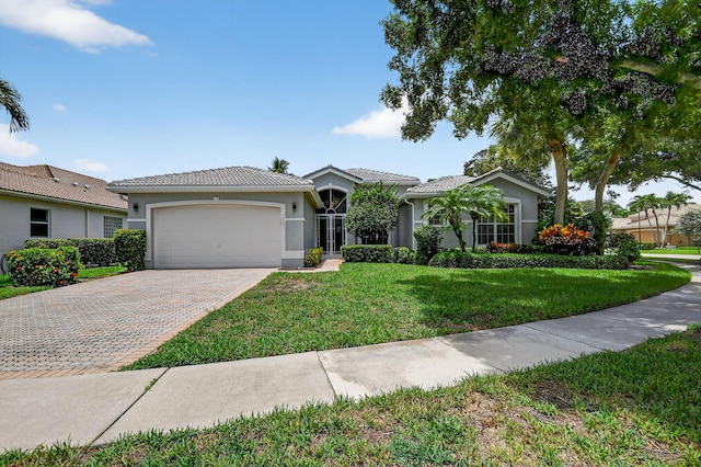 11291 Barca Blvd, Boynton Beach, FL 33437 - ranch-style house featuring a garage, stucco siding, driveway, a front lawn, and a tiled roof
