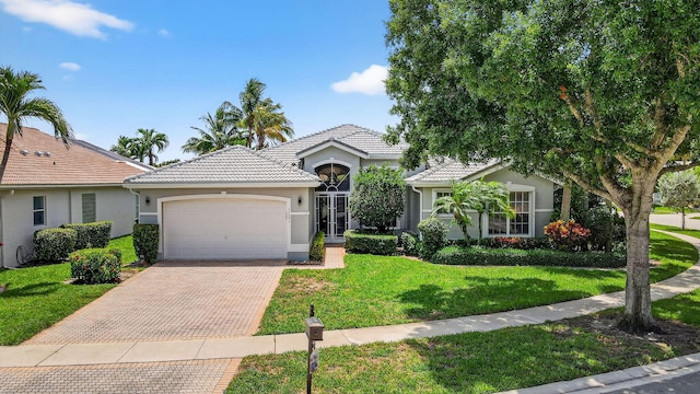 11291 Barca Blvd, Boynton Beach, FL 33437 - ranch-style home with stucco siding, an attached garage, decorative driveway, a front yard, and a tile roof