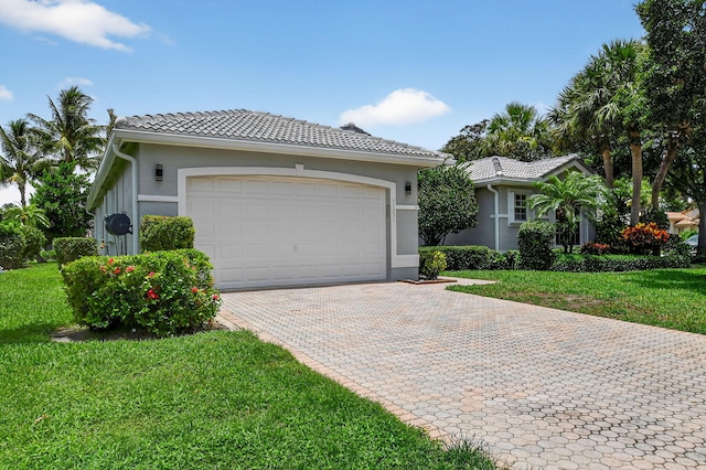 11291 Barca Blvd, Boynton Beach, FL 33437 - view of front of home featuring a tiled roof, a front lawn, decorative driveway, and stucco siding