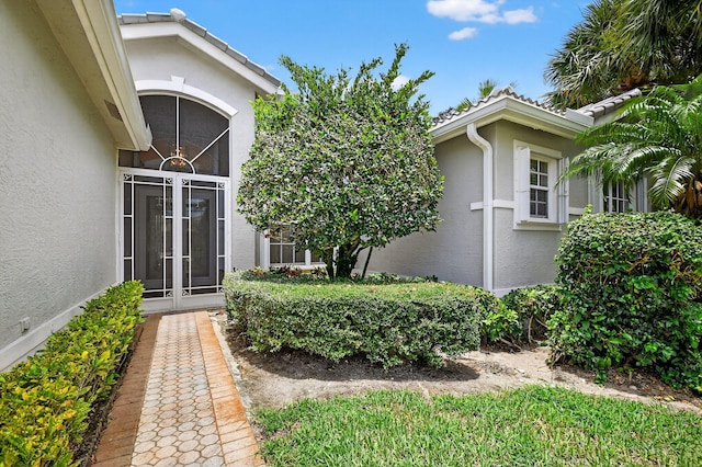 11291 Barca Blvd, Boynton Beach, FL 33437 - doorway to property featuring stucco siding and a tiled roof