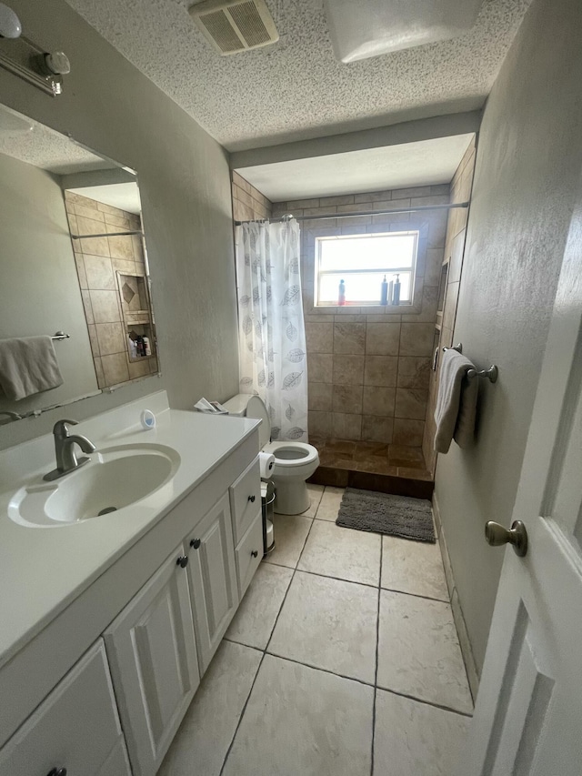 1186 Camprock Rd, West Palm Beach, FL 33417 - bathroom featuring vanity, a tile shower, tile patterned floors, and a textured ceiling